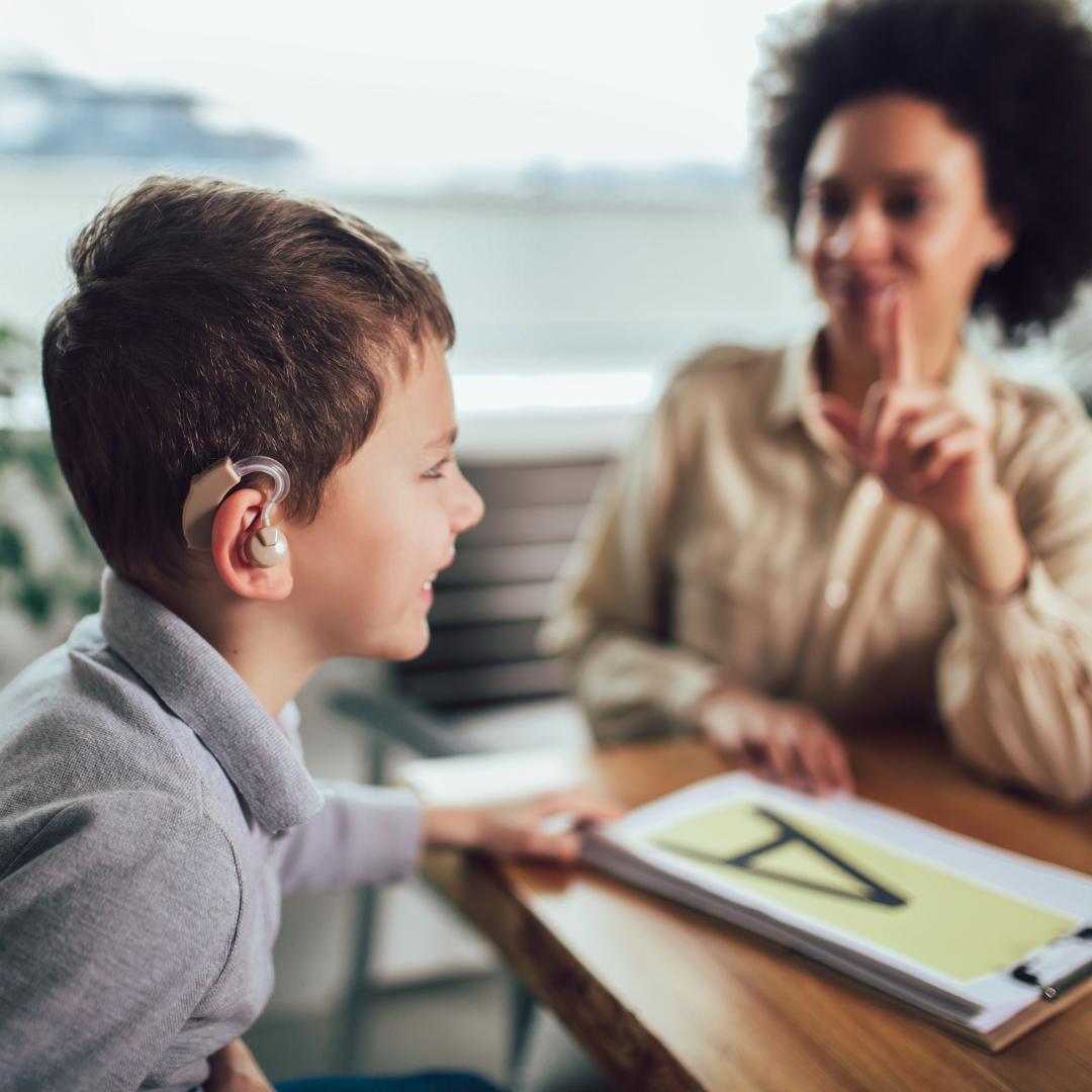 Teacher and a student who is wearing a hearing aid